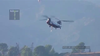 Chinook Firefighting Helicopter Arriving at a Reservoir to Refill Water Tank