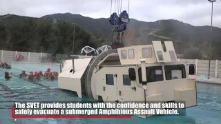 Assault Amphibian School students take a ride in the Submerged Vehicle Egress Trainer