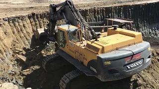 Volvo EC700BLC Excavator Loading Caterpillar Dumpers