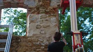 Rebuilding the fallen wall of the chateau ruin.