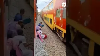 Indian woman pulls death defying stunt infront of speeding train | Watch Video| Oneindia News