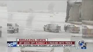 NOON: Plane skids off runway at LaGuardia, crashes through fence