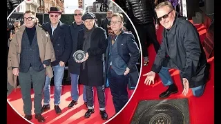 Madness' Suggs beams as he unveils tribute slab at Camden's Music Walk of Fame with bandmates