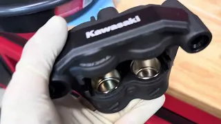 Kawasaki ZX-4RR brake caliper cleaning and new pad installation.