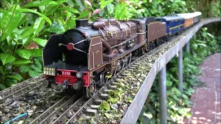 A CIWL train with Brown Wooden and Blue Metal cars with a NORD Pacific Chapelon