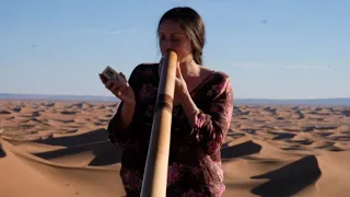 Playing didgeridoo in the desert of Morocco