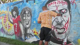 Artist repaints vandalized George Floyd mural in Miami