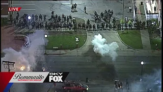 Protesters throwing fireworks and other objects at police in Ferguson