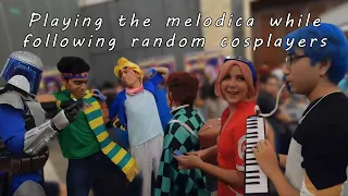 Playing the melodica while following random cosplayers