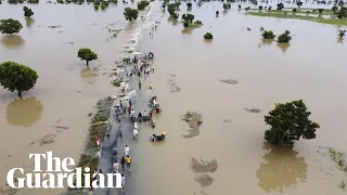 'Like something you watch in a movie': climate crisis intensifies with catastrophic floods