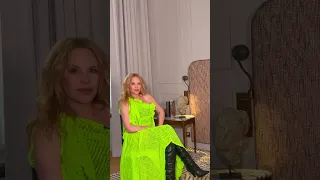 Kylie Minogue green dress and black leather boots