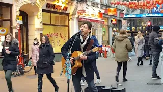 singer doing a Bob Dylan song in London .blowin' in the wind.