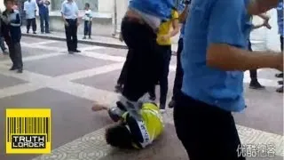 Chinese officer jumps on bike shop worker's head during fight - Truthloader