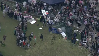 Demonstrators knock down barriers surrounding MIT encampment