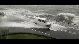 Eyewitness footage shows waves splashing over cars on a coastal road in the west of Scotland