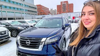 2024 Nissan Pathfinder SL Deep Ocean Blue Pearl Exterior - review from a dealership in a snow storm