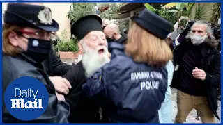 'Pope, you are a heretic!' Police tackle heckling Orthodox priest