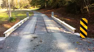 Low cost timber deck bridge