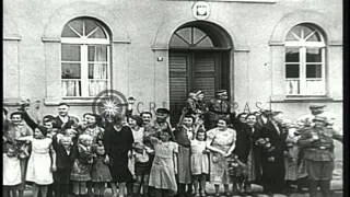 German soldiers are welcomed by peasants who throw flowers and raise hands in Naz...HD Stock Footage