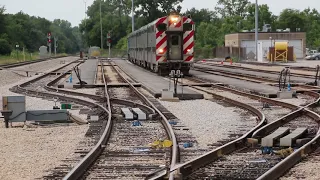 The last cab car with a brass bell leads a train out of Orland Park 179th Street