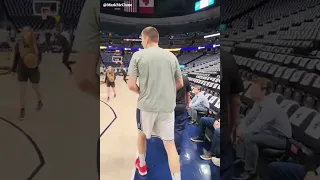 Nikola Jokic catching up with Suns Owner Mat Ishbia with a hug after finished his pre game routine