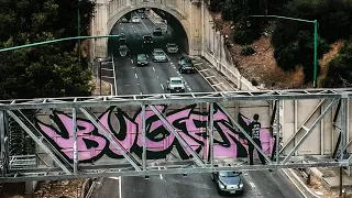 BROAD DAYLIGHT GRAFFITI | BUGE (BAMC) on HIGHWAY SIGN over SPEEDING TRAFFIC on the 110 FWY in LA