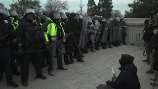 Police in riot gear stand guard outside Capitol | AFP
