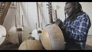 Jali kora player Sam Sussoh with 'KORA manding harps'