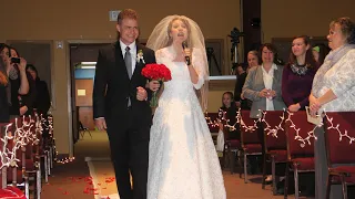 Bride surprises groom by singing down the aisle.  Most amazing wedding ever!
