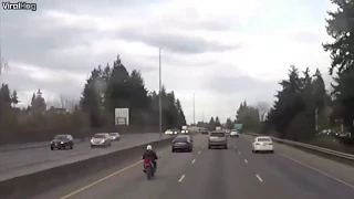 Motorcyclist crashes into car and lands on trunk