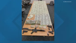 2 arrested for guns, drugs and cash