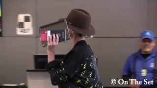 Charlize Theron Hides From Paparazzi at LAX for International Flight