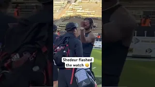 Shedeur Sanders flexed his watch to Huskers players standing on the logo