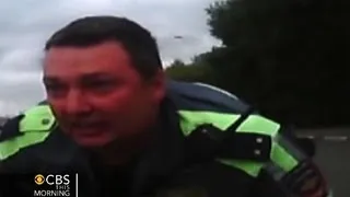 Watch: Russian police officer clings to hood of car