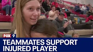 Teammates support injured volleyball player