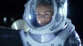 female ASTRONAUT wearing space suit works on a laptop exploring newly discovered 🚀👩🏻‍🚀👨🏻‍🚀🛸🛰👨‍🚀👩‍🚀