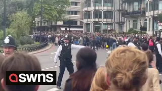 Crowds gathered in London surge past police to get glimpse of Queen's funeral procession | SWNS