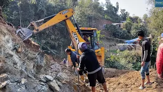 Mountain Villagers and JCB Backhoe Working Together for this Rocky Mountain Road