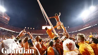 College football fans storm field and topple goalposts