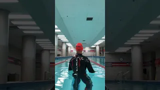 Swimming with a wetsuit in a pool