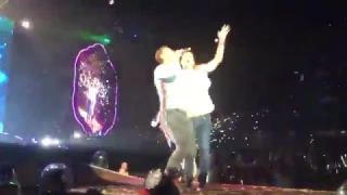 Fan jumps on stage to dance with Chris Martin