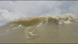 Brown beach water at Galveston, Texas, June 2019