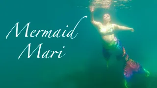 Mermaid Mari swims through the clear ocean water