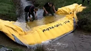 Installing and removing a portable dam (Water-Gate water barrier)