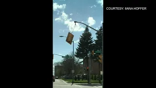 Stoplight dangles in the wind after storm hits GTA