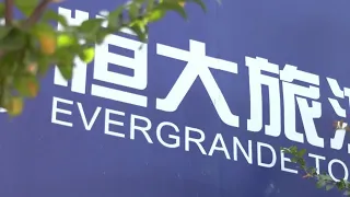 Evergrande shares plunge after new debt warning