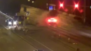 Surveillance video shows Tesla running red light before major crash