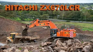 Hitachi ZX670 loading stone on a road project