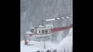 Dangerous helicopter Take off in snowy mountains