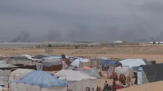 Smoke rises from Gaza Strip while displaced residents live in tents amid a constant struggle for foo